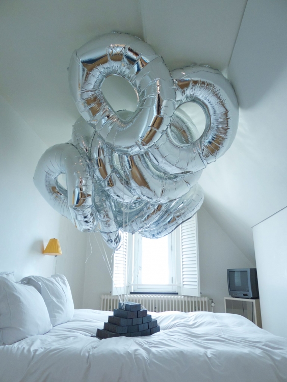 "Public Offering", 2013, bricks, balloons. Installation at the Lloyd Hotel Amsterdam. Photo: Gert Jan van Rooij "Public Offering", 2013, bricks, balloons. Installation at the Lloyd Hotel Amsterdam. Photo: Gert Jan van Rooij